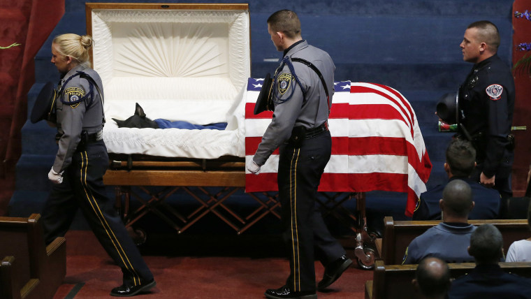 Police officers file past the casket of Oklahoma City police canine officer K-9 Kye during funeral services in Oklahoma City, Thursday, Aug. 28, 2014....