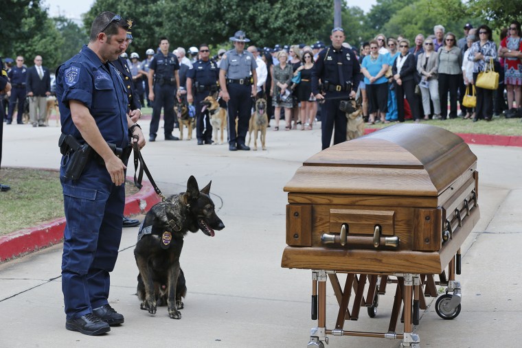 Canine officers and their handlers from around the state stopped at the casket of K-9 Kye following funeral services for the dog in Oklahoma City, Thu...