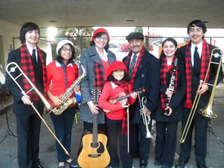 The five children in the Burgos family have all studied a musical instrument and excel in school. From left, Stephen, 20, Monica, 16, mom Maria Elena, Theresa, 11, dad Rene, Elizabeth, 22, and Martin, 18.