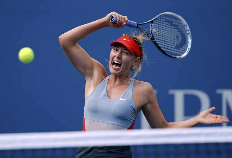 Maria Sharapova of Russia hits a return to Caroline Wozniacki of Denmark during their match at the 2014 U.S. Open tennis tournament in New York, Augus...