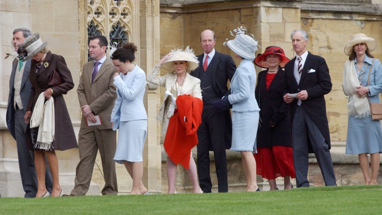 Joan Rivers death. File photo dated 09/04/05 of Joan Rivers (centre, holding red coat) arriving at St George's Chapel at Windsor Castle, for the bless...