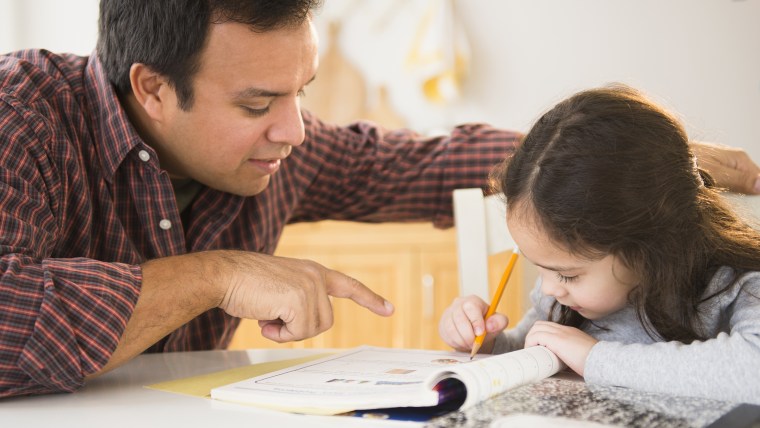 Father helping daughter with homework