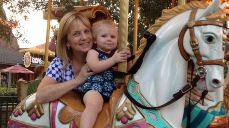 Granddaughter Noelle Dunham and her grandmother is Cynthia Petersen on the merry-go-round- at Downtown Disney.