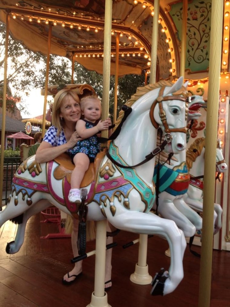 Granddaughter Noelle Dunham and her grandmother Cynthia Petersen on the merry-go-round- at Downtown Disney.