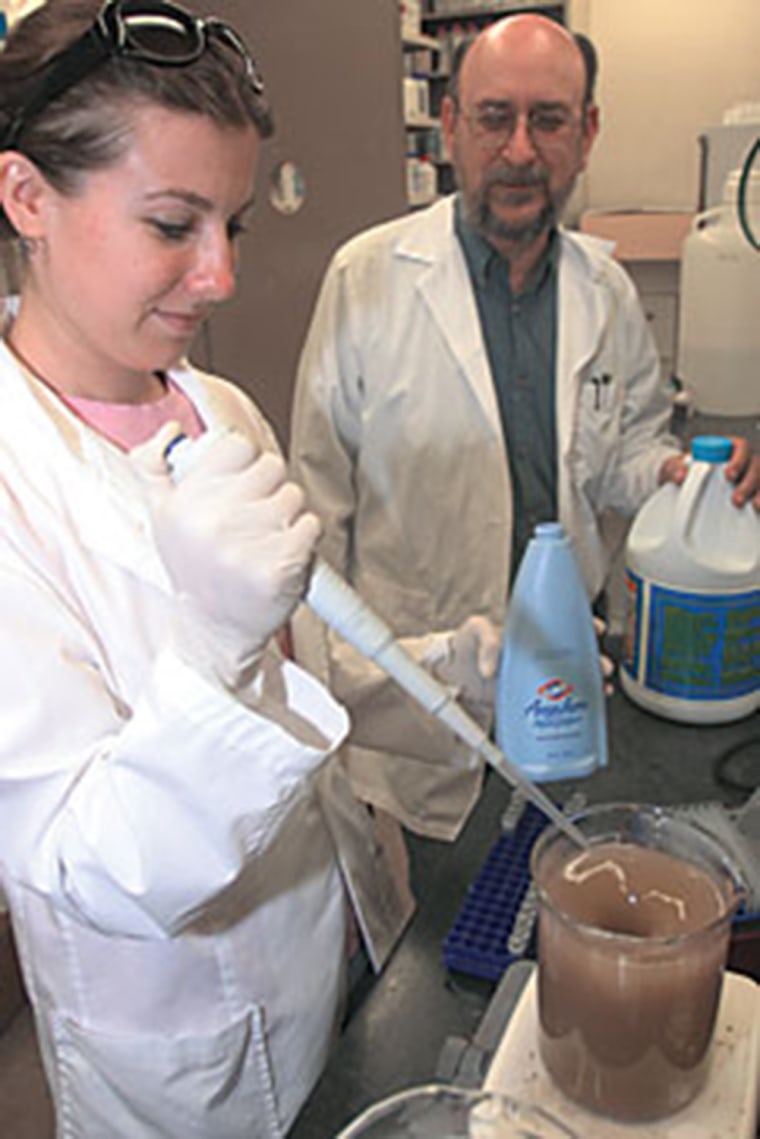 Dr. Charles Gerba and a student work on samples for their study of office germs.