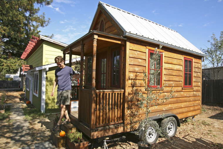 Jay Schafer, owner of Tumbleweed Tiny Houses, exits a tiny house he built for himself in Graton, Calif., in this Oct. 14, 2010, photo.