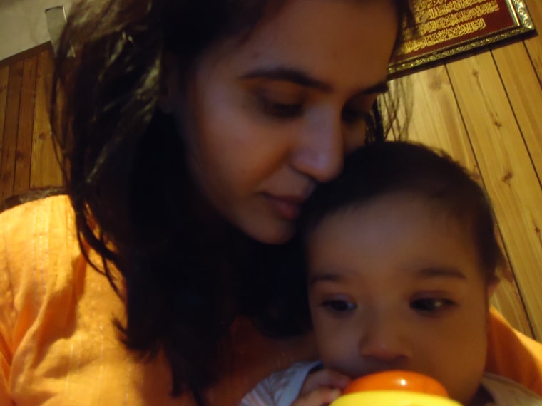 Mansoor Khalid's wife with their son.