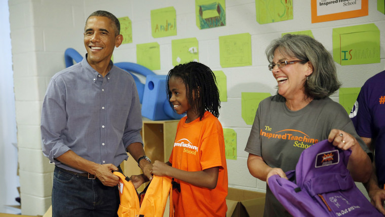 U.S. President Barack Obama helps fill backpacks with items to give to homeless children while participating in a service project at The Inspired Teac...
