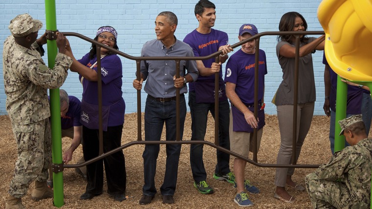 epa04396547 US President Barack Obama (C-L) and his wife Michelle Obama takes part in a service project at the Inspired Teaching School to commemorate...