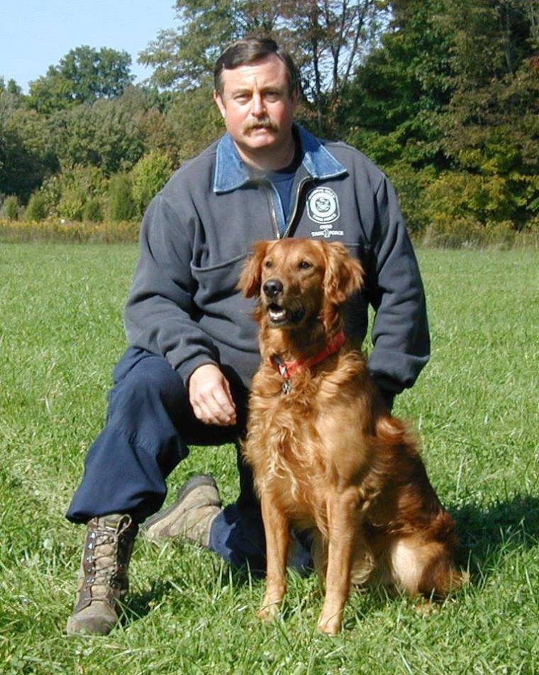 Terry Trepanier, a career firefighter, is pictured in 2002 with his search dog Woodie. The pair worked at Ground Zero from Sept. 11 to 17, 2001 with Ohio Task Force 1. Today, at age 15, Woodie is happily retired.