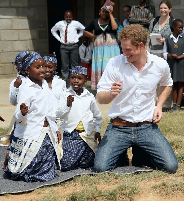 MASERU, LESOTHO - FEBRUARY 27: Prince Harry dances with deaf children during at visit to the Kananelo Centre for the deaf, a project supported by his ...