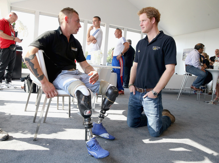 GAYDON, ENGLAND - SEPTEMBER 09:  Prince Harry chats to David Birrell of the British Team at the Jaguar Landrover driving Challenge, the first event in...