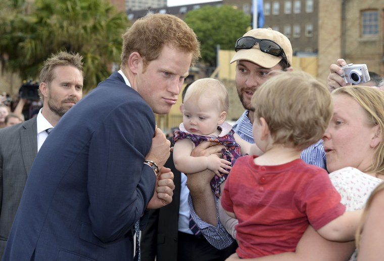 Prince Harry makes a funny face at a young child as he is greeted by a large crowd during the International Fleet Review in Sydney, Saturday, Oct. 5, ...