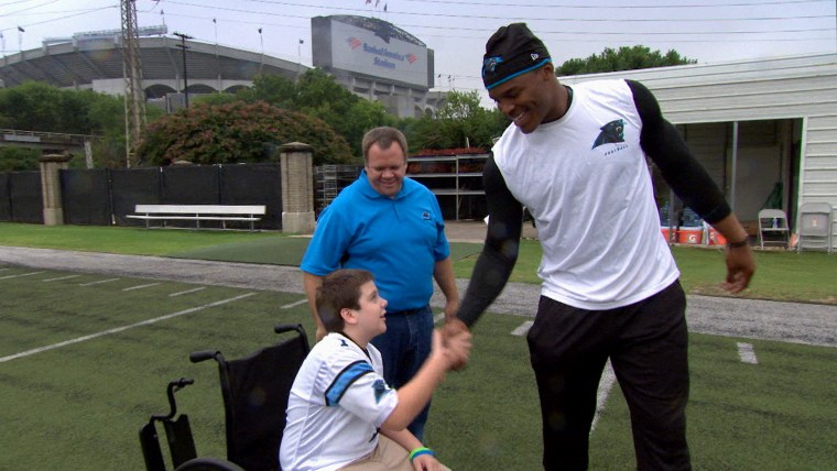 Carolina Panthers fan Austin Smith, 13, who has cerebral palsy, meets his favorite player, Panthers quarterback Cam Newton, as part of TODAY's "Together We Make Football" series. 