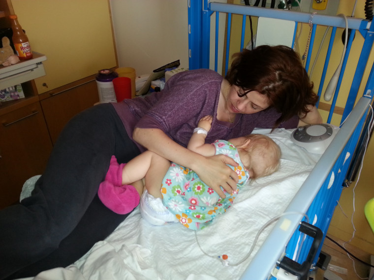 I'm here for you: Nicole Kabel lays with her daughter, Sally, as she undergoes her first chemotherapy treatment for leukemia.