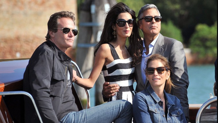 George Clooney, top right, his fiancee Amal Alamuddin, Cindy Crawford, bottom right and her husband Rande Gerber arrive in Venice, Italy, Friday, Sept...
