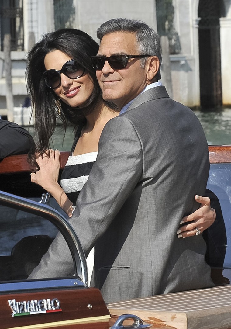George Clooney and his fiancee Amal Alamuddin arrive in Venice, Italy, Friday, Sept. 26, 2014. Clooney, 53, and Alamuddin, 36, are expected to get mar...