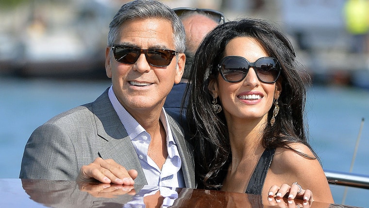 George Clooney ( L) and his Lebanon-born British fiancee Amal Alamuddin take a taxiboat upon their arrival in Venice on September 26...