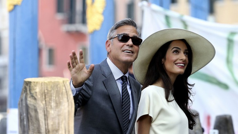 U.S. actor George Clooney and his wife Amal Alamuddin arrive at Venice city hall for a civil ceremony to formalize their wedding in Venice September 29