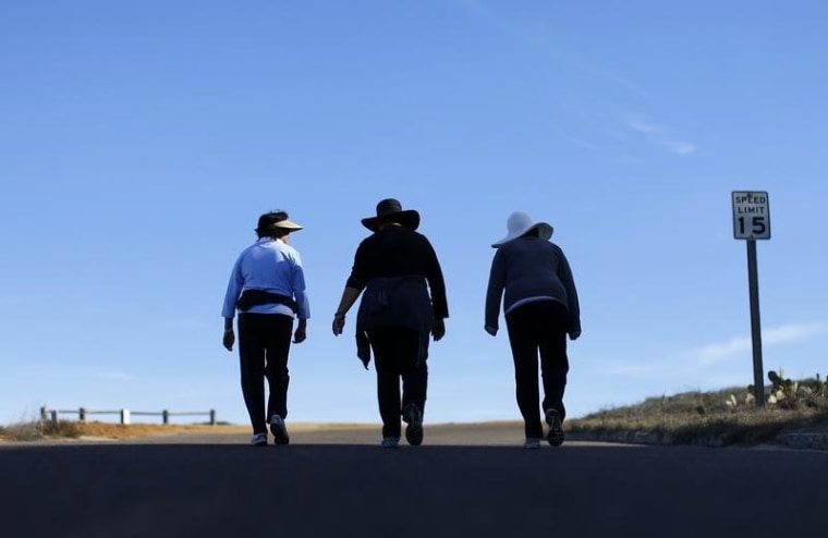 Women walk together up a hill as they participate in some morning exercise during a visit to Torrey Pines State Park in San Diego, California, Novembe...