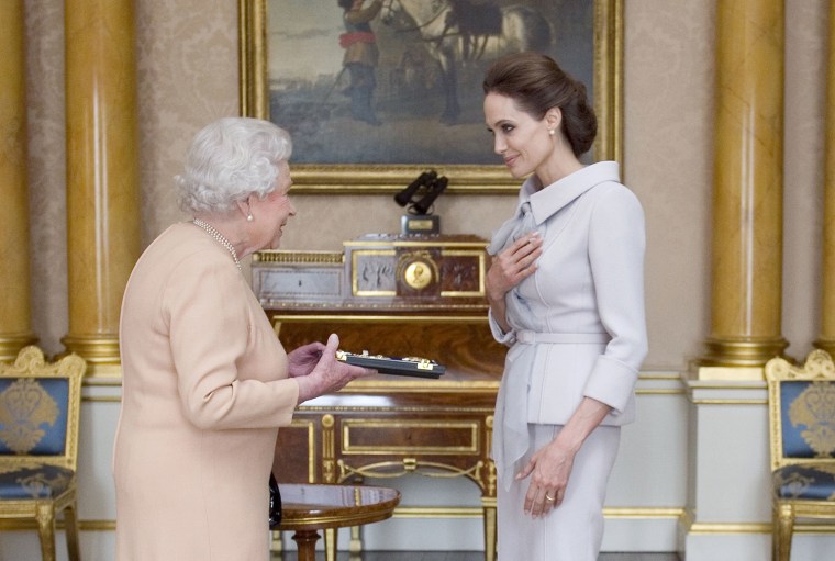 U.S actress Angelina Jolie, right, is presented with the Insignia of an Honorary Dame Grand Cross of the Most Distinguished Order of St Michael and St...