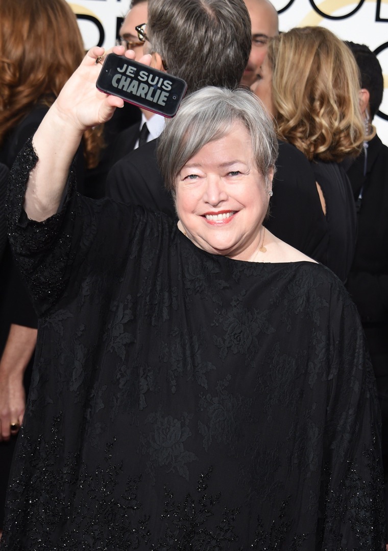 Image: Actress Kathy Bates shows a \"Je suis Charlie\" on her phone as she arrives on the red carpet for the 72nd Annual Golden Globe Awards, January 11, 2015 at the Beverly Hilton Hotel in Beverly Hills, California.