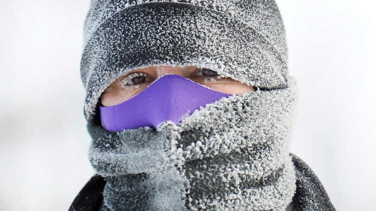 Caroline Hale of Minneapolis, pauses during a run in -25 degrees Celsius weather