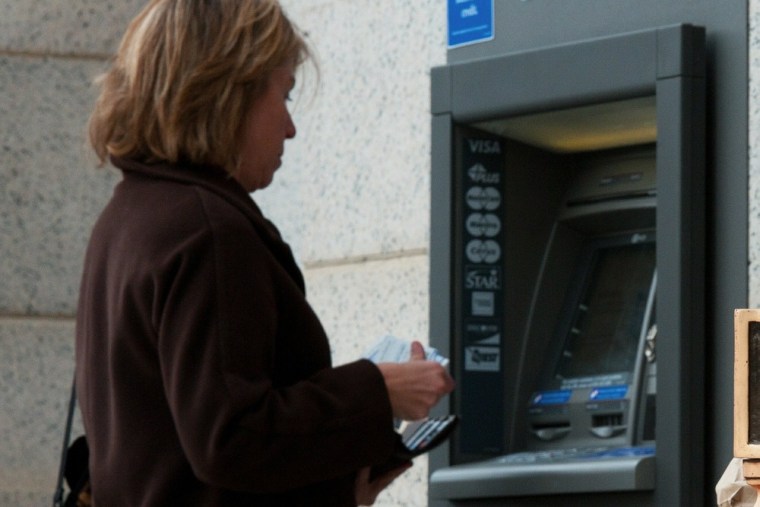 A woman uses the ATM