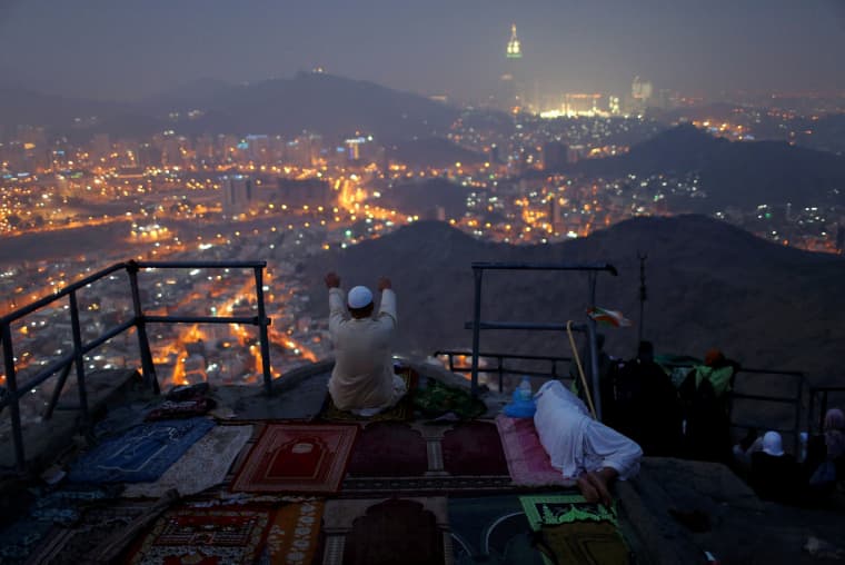 Image: A pilgrim prays at Mount Al-Noor ahead of the annual haj pilgrimage in the holy city of Mecca