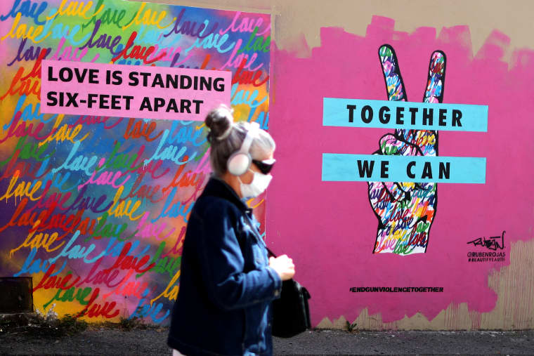 Image: A woman walks past a mural painted by Ruben Rojas as part of the campaign to create 1,000 murals on closed businesses created by the company Beautify, as the global outbreak of the coronavirus disease (COVID-19) continues, in Santa Monica