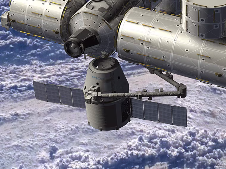 An artist's conception shows SpaceX's Dragon capsule delivering cargo to the international space station.