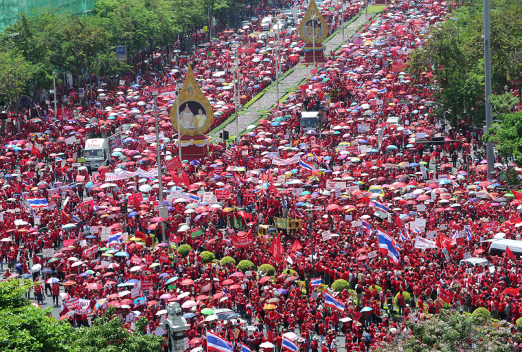 Image: Supporters of Thailand's ousted premier Thaksin Shinawatra march along the main street during a demonstration in Bangkok.