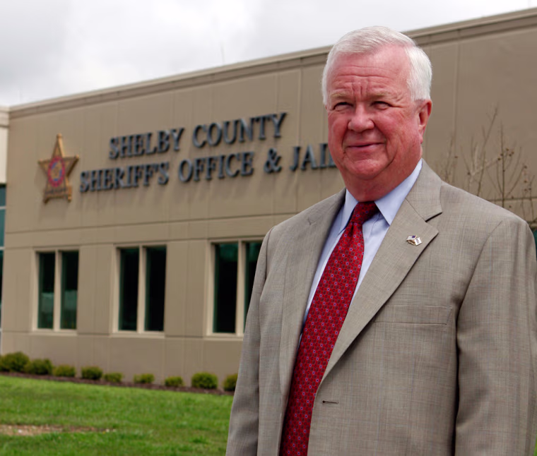 Shelby County Sheriff Chris Curry stands in front of the Sheriff's Office in Columbiana, Ala. on Thaursdy, April 2, 2009. Curry found out firsthand last Aug. 20 that the drug war, and the savagery it brings, had landed in his back yard with the brutal killing of five men at an apartment complex in Alabama's wealthiest county. (AP Photo/Butch Dill)