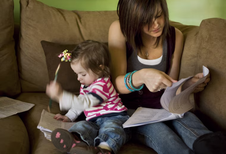 Ashley Van Wormer, 20, studies for a GED test in the company of her one-year-old daughter Payton in Elkhart, Indiana.