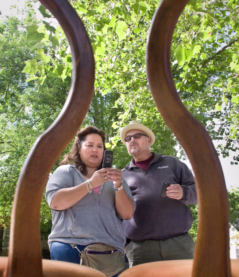 Mary Uhazi took camera phone photos of a chair set to help make a sale to Stan Brodeur (pictured) of Sacramento during her garage sale in East Sacramento.