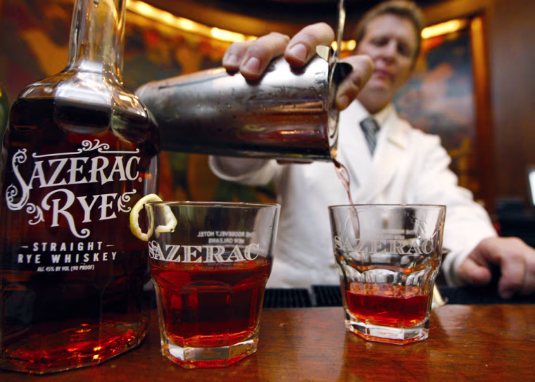 Image: a bartender perpares a cocktail