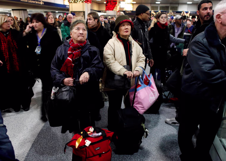 Image: Travelers wait for word on train delays at Penn Station