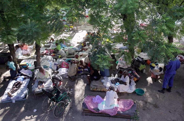 Image: Patients lay camped outside their quake damaged nursing home in Port-au-Prince