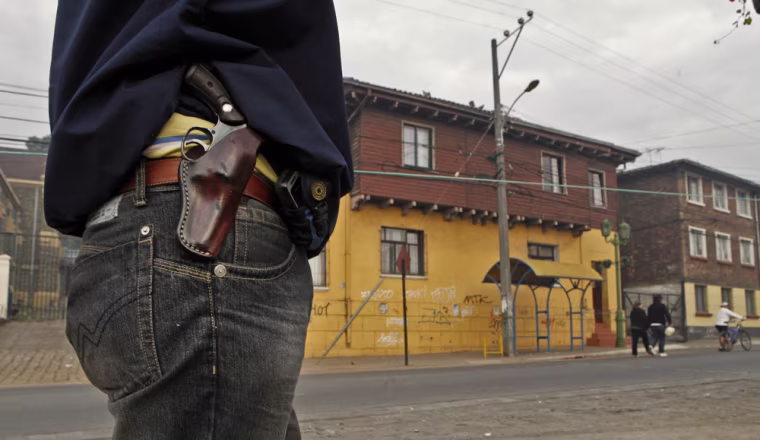 Image: armed man guards his block