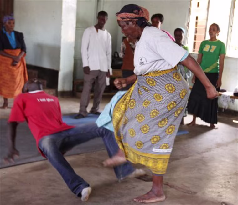 ** ADVANCE FOR MONDAY, MAY 17 ** In this photo taken March 3  2010, in Nairobi's Korogocho,  one of Kenya's  most dangerous slums, elderly women practice self defense moves. Elderly women in slums across Nairobi are increasingly being targeted by rapists. Officials say some rapists believe that  attacking older women can cure AIDS, while others believe that it will bring them good fortune. (AP Photo/Khalil Senosi)