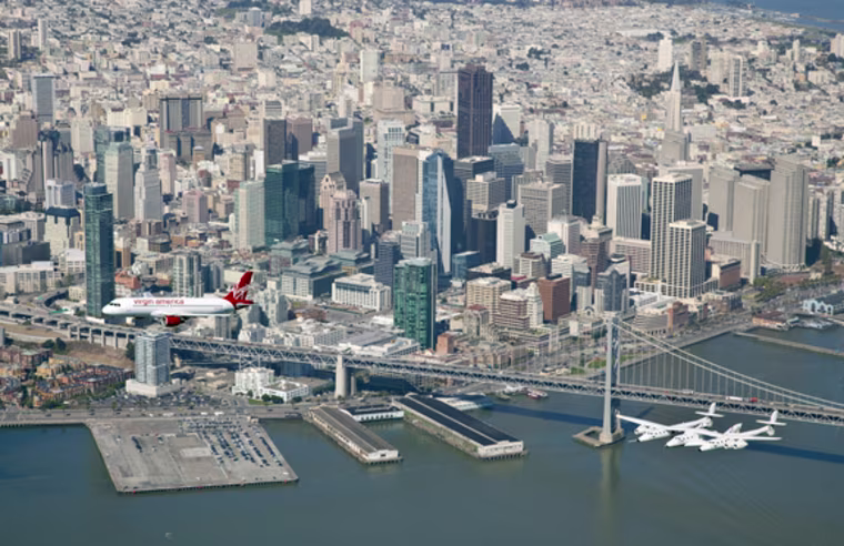 April 6, 2011 San Francisco-\"MY OTHER RIDE IS A SPACESHIP\"- A new Virgin America A320 aptly named \"My Other Ride is a Spaceship\"  flys in tandem with White Knight2 carrying Spaceship 2 April 6, 2011. The aircraft were on their way to landing at San Francisco International Airport as the first aircraft to arrive at the new $388 million 640,000 square foot Terminal 2, which is slated to be the first LEED-GOLD certified airport in the nation. Guests onboard the A320 included Virgin Group Founder Sir Richard Branson and astronaut Buzz Aldrin.
credit: Mark Greenberg/Virgin America  NO SALES  handout photo