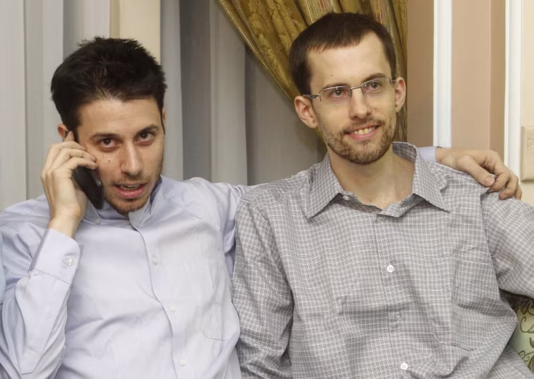 Image: American hikers Shane Bauer and Josh Fattal sit in Tehran's Mehrabad airport
