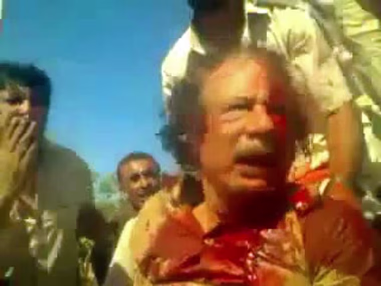 Image: A grab from a video taken from the mobile phone of a National Transitional Council (NTC) fighter shows the capture of Libya's strongman Moammar Gadhafi in Sirte on October 20