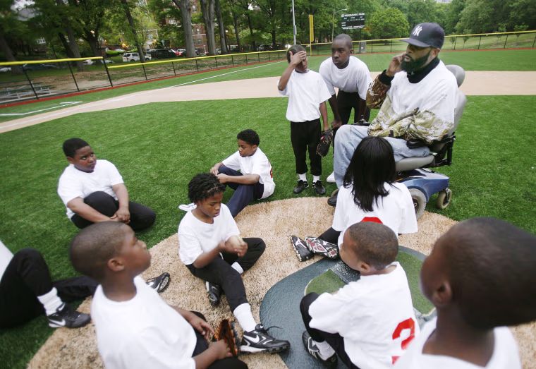 Coach Rodney Mason talks to the Newark Eagles Little League team after they suffered an emotional loss against the Philly Stars at Weequahic Park on May 14, 2008.
