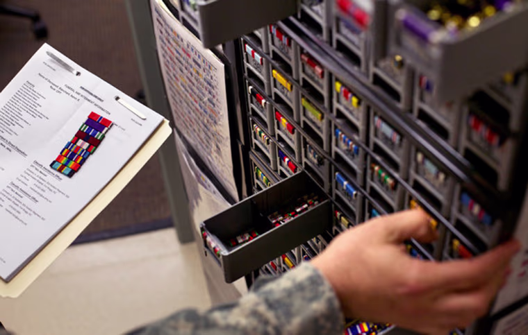 Image: Sergeant Deynes assembles the badges, medals, unit patches and ribbons