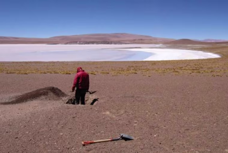 Jonathan Perkins, along with his advisor, Noah Finnegan (he's behind the camera), conduct field work in the barren landscape surrounding the volcano.