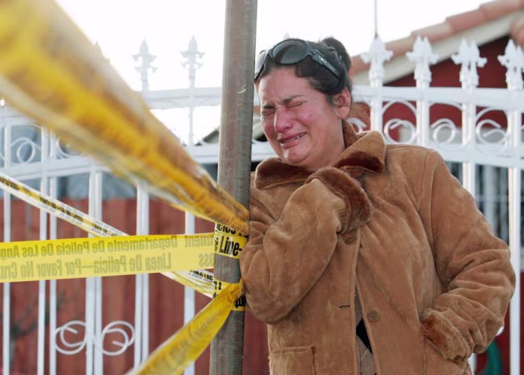 Image: Audelia Birucel, 38, from San Pedro, Calif. who was visiting relatives in the neighborhood, cries after learning that a man apparently distraught about losing his job killed his wife and five children before committing suicide