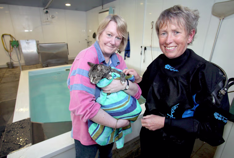 Image: Veronica Ashworth (left) holds her cat, Mog, after a swimming session at Hawksland hydrotherapy pool
