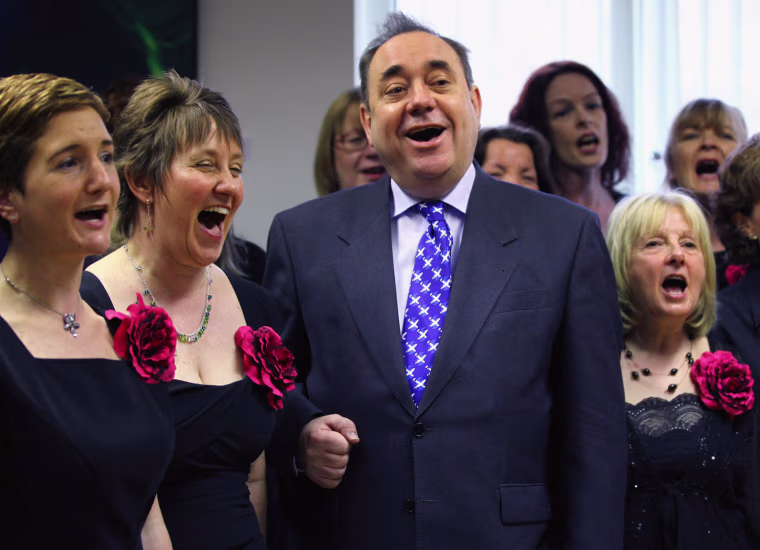 Image: Scotland's First Minister Alex Salmond sings with a choir on the campaign trail.