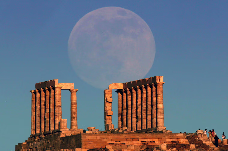 Image: The moon rises over the temple of Poseidon in Cape Sounion east of Athens